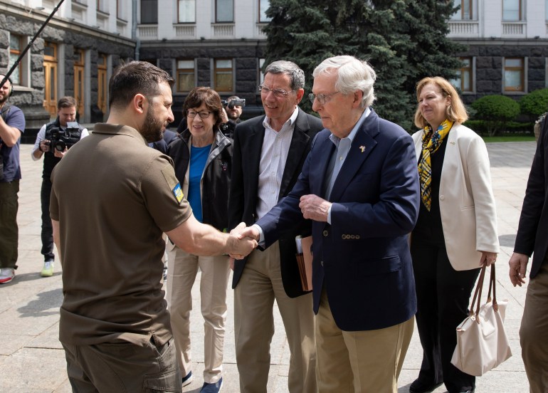 In this handout photo provided by the Ukrainian Presidential Press Office, Ukrainian President Volodymyr Zelenskyy, left, shakes hands with Senator Mitch McConnell in Kyiv, Ukraine on Saturday, May 14, 2022 [Ukrainian Presidential Press Office via AP]