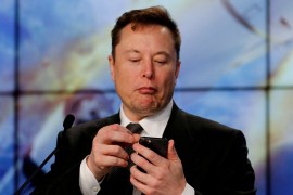 Elon Musk looks at his mobile phone in Cape Canaveral, Florida, U.S