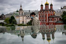 A man walks past Russian Orthodox cathedrals at the Zaryadye park in Moscow