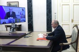 Russian President Vladimir Putin chairs a meeting on economic issues via a video link, with Prime Minister Mikhail Mishustin and other officials seen on a screen, at the Kremlin in Moscow, Russia