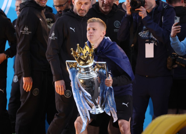 Manchester City's Oleksandr Zinchenko celebrates with the Premier League trophy during the victory ceremony, May 23, 2022
