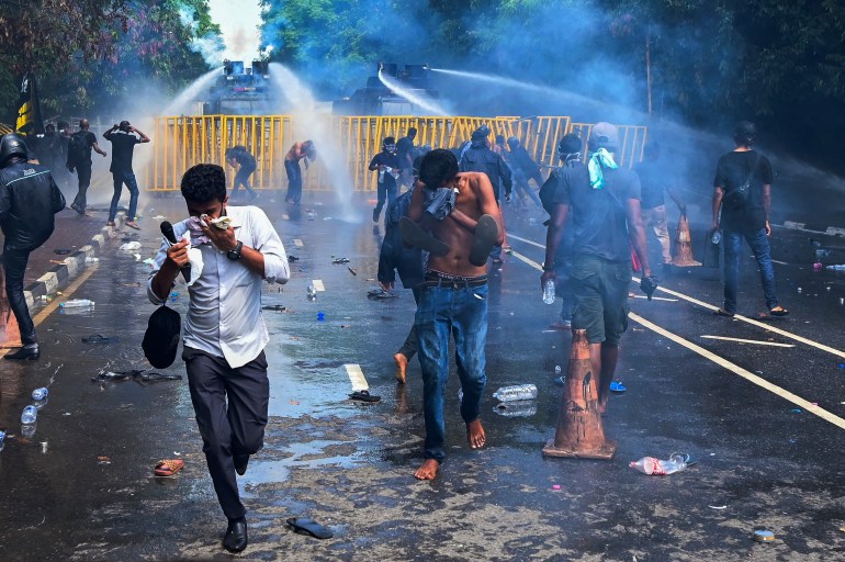 Police use a water canon and tear gas to disperse university students protesting