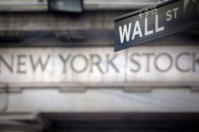 A Wall Street sign is pictured outside the New York Stock Exchange in New York