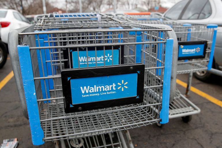 Walmart shopping carts are seen on the parking lot