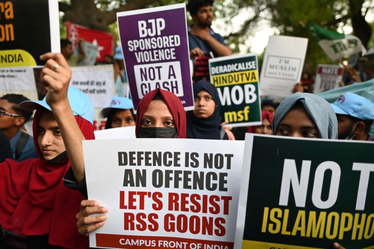 Protestors hold placards during a demonstration against anti-Muslim violence and hate crimes in New Delhi