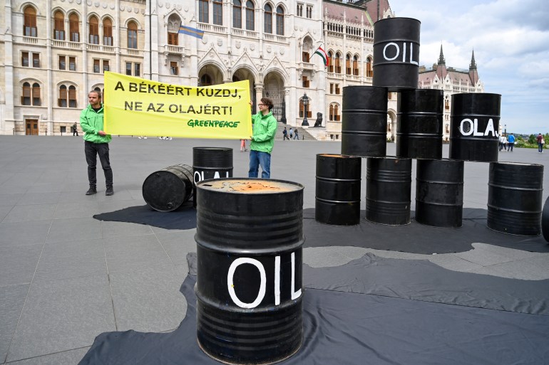 Oil barrels are seen during a protest action of independent global campaigning network Greenpeace in front of the parliament building in Budapest, Hungary on May 30, 2022, to demand from the Hungarian government not to oppose EU sanctions on Russian oil