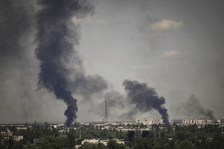 Smoke rises from the city of Severodonetsk, during shelling in the eastern Ukrainian region of Donbas [Aris Messinis/AFP]