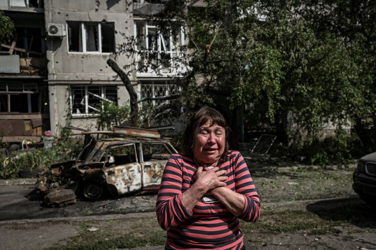 A woman reacts outside a damaged apartment building after an attack in the city of Sloviansk at the eastern Ukrainian region of Donbas.