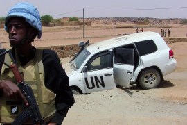 A photo taken in 2016 shows a soldier of the United Nations mission to Mali guarding a UN vehicle after it drove over an explosive device in northern Mali [Souleymane Ag Anara/AFP]