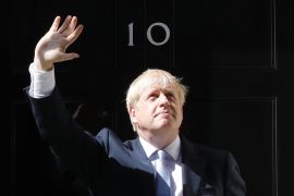 Boris Johnson raises his hand outside 10 Downing Street