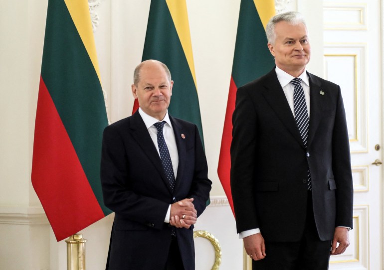Lithuania's President Gitanas Nauseda (R) welcomes German Chancellor Olaf Scholz (L) at the presidential palace in Vilnius