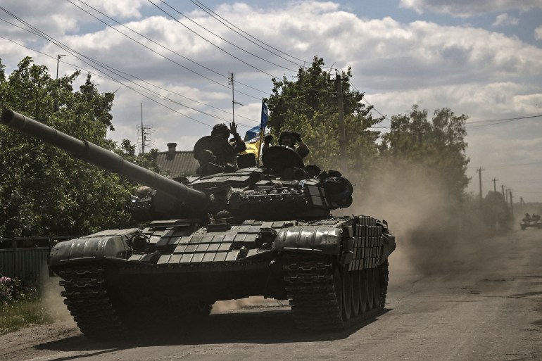 Ukrainian troops are seen moving in a tank, towards the front line in the Donbas