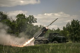 Ukrainian troops fire surface-to-surface rockets towards Russian positions at a front line in the eastern Ukrainian Donbas region [Aris Messinis/AFP]