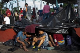 Migrants taking part in a caravan heading to the US, are seen at a makeshift camp in Huixtla, Chiapas state
