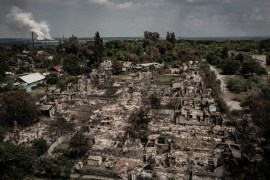 An aerial view shows destroyed houses after strike in the town of Pryvillya at the eastern Ukrainian region of Donbas on June 14, 2022,