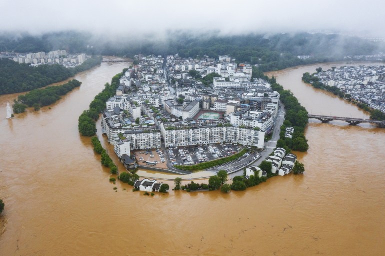 This aerial photo taken on June 20, 2022 shows flooded streets and buildings following heavy rains in Wuyuan, in China's central Jiangxi province