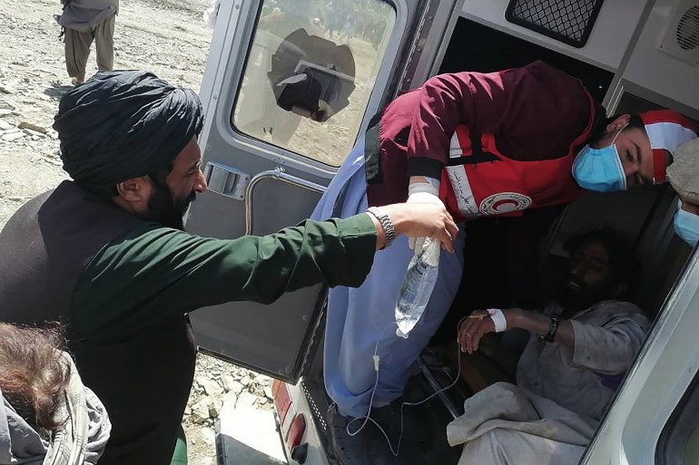 A medic helps a man in an ambulance