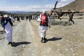 Soldiers and Afghan Red Crescent Society officials near a helicopter at an earthquake-hit area in Afghanistan&#39;s Gayan district, Paktika province. [Bakhtar News Agency via AFP]