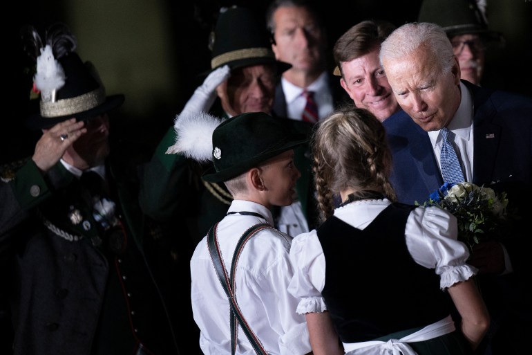US President Joe Biden (R) is greeted by children wearing traditional Bavarian clothes upon his arrival at the Franz Josef Strauss Airport in Munich, southern Germany on June 25, 2022, on the eve of the G7 summit. 