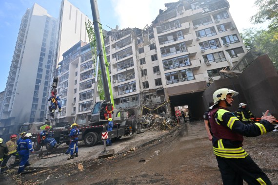 Ukrainian rescuers work outside a damaged residential building hit by Russian missiles in Kyiv on June 26, 2022, amid Russian invasion of Ukraine. - "The G7 summit must respond with more sanctions against Russia and more heavy weapons for Ukraine," urged on June 26, 2022 Dmytro Kouleba, the head of Ukrainian diplomacy, on Twitter, calling for "defeating the sick Russian imperialism.