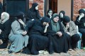 Palestinian women sitting down and mourning