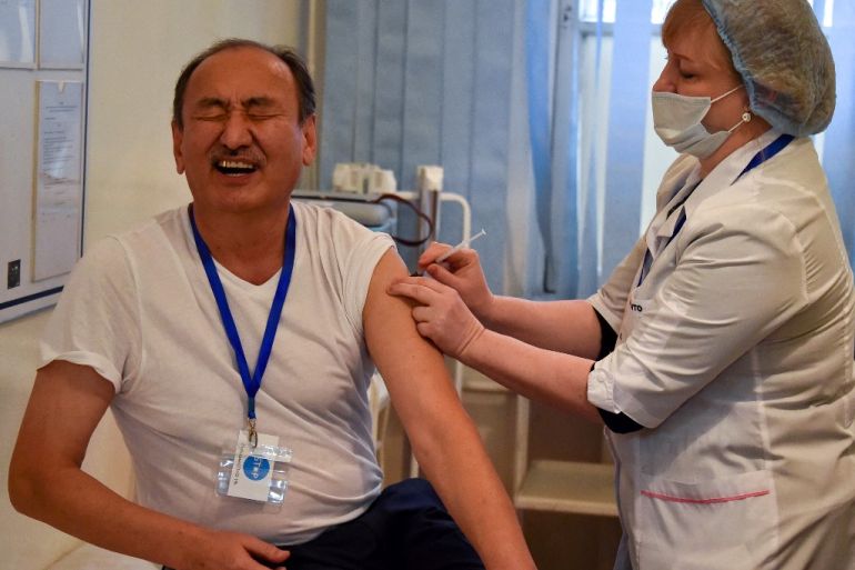 Kyrgyz Health Minister Alymkadyr Beishenaliyev receives a dose of the Sinopharm vaccine