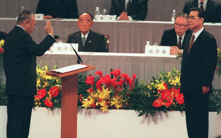 Tung Chee-hwa takes an oath opposite Chinese Prime Minister Li Peng during his swearing-in ceremony in 1997.