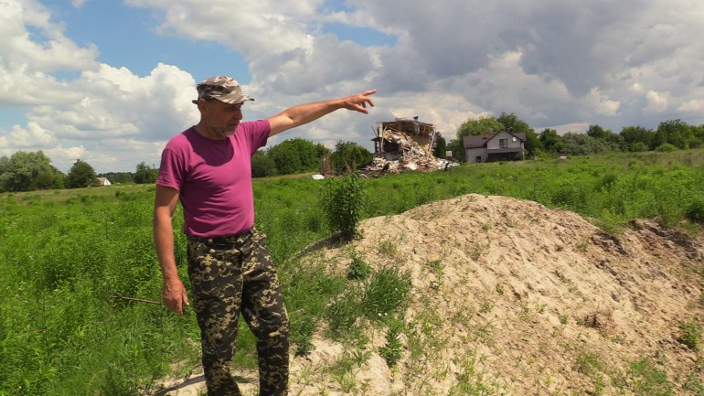 Yuri Dovgan near a crater left by a Russian bomb on March 9 in Makariv