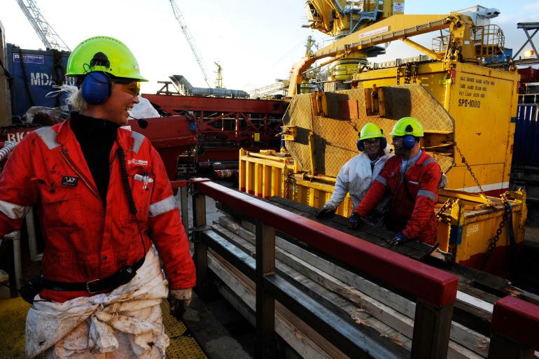 Oil workers are pictured as they work at the Oseberg oil field, in the North Sea