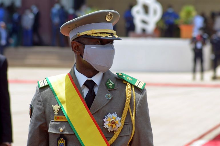 Mali coup leader Colonel Assimi Goita, in uniform with a yellow sash across his shoulder, at a ceremony where he became president.