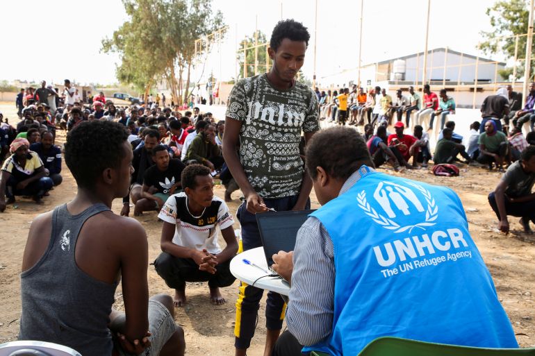 Migrants inside the Ain Zara detention centre, Libya, speak to an UNHCR officer.
