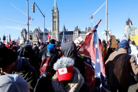 A person carries a Confederate battle flag at Parliament Hill in Ottawa, Canada