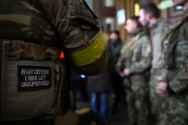 A badge on a uniform of a foreign fighter from the UK as he and other volunteers prepare to depart towards the front line in the east of Ukraine in March 2022 [Kai Pfaffenbach/Reuters]
