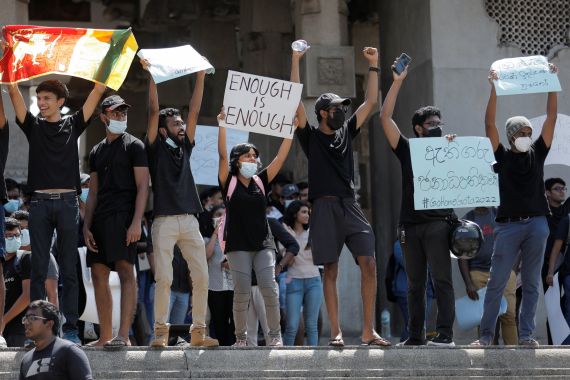 People shout slogans and hold signs during a protest in Colombo, Sri Lanka.