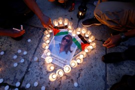 People light candles during a vigil in memory of Al Jazeera journalist Shireen Abu Akleh