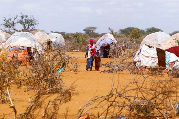 Civilians walk at the Kaxareey camp for the internally displaced people in Dollow, Gedo region of Somalia.