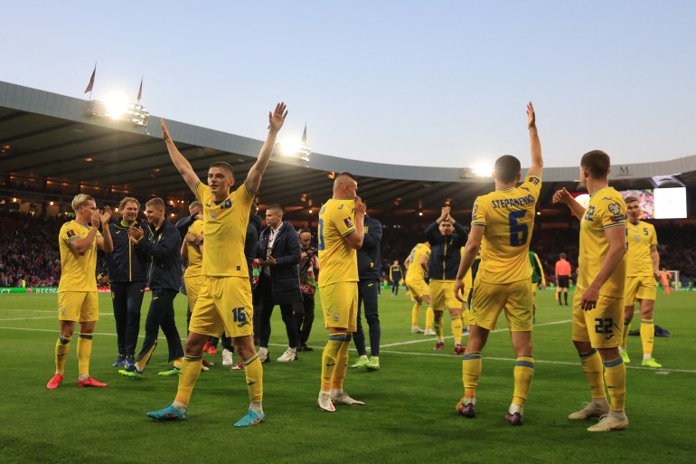 Ukrainian players celebrate on the pitch and wave to fans after their victory over Scotland at Hampden Park in Glasgow