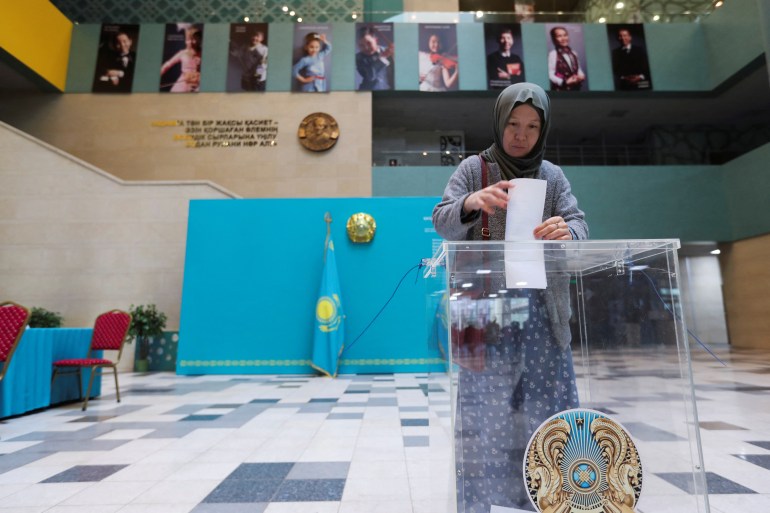 A voter casts her ballot during a constitutional referendum at a polling station in Nur-Sultan, Kazakhstan.