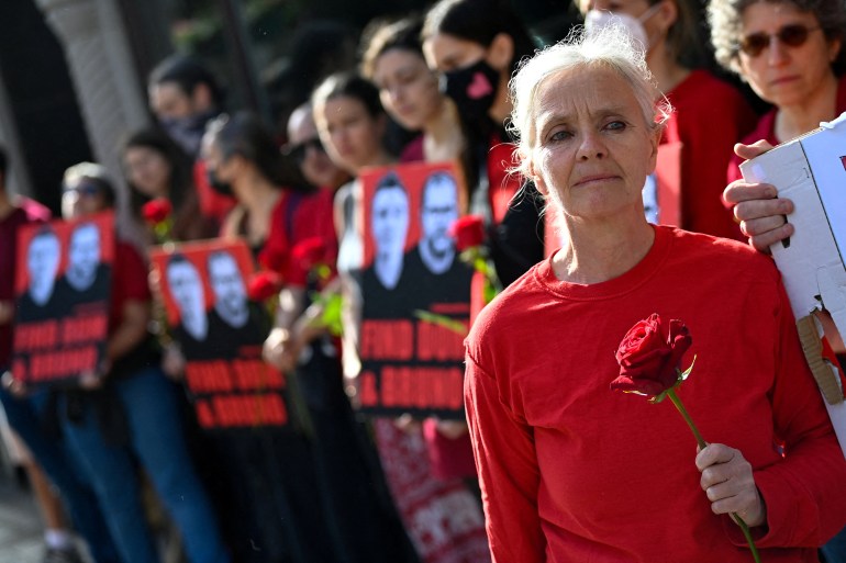 Sian Phillips, sister of missing journalist Dom Phillips, holds a rose at a protest outside the Brazilian embassy in London, UK