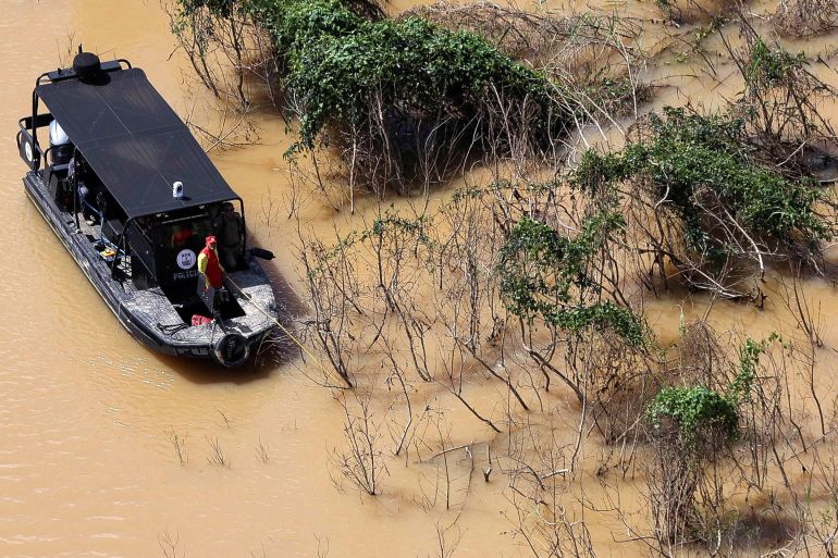 Police officers and rescue team conduct a search operation for British journalist Dom Phillips and indigenous expert Bruno Pereira along a milky brown river in the Amazon