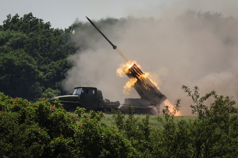 Ukrainian service members fire a BM-21 Grad multiple rocket launch system, near the town of Lysychansk, Luhansk region