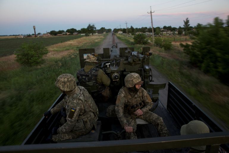 Ukrainian troops are seen riding in a truck in the country's southern Mykolaiv region