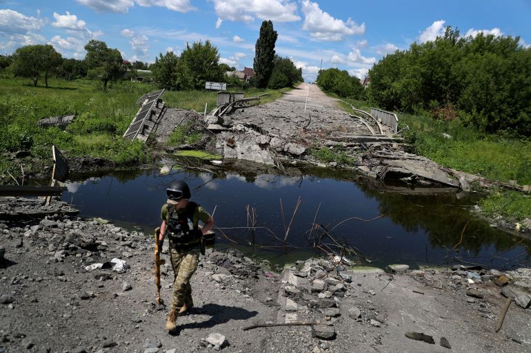 A view of a damaged road at a former Russian-occupied village, amid Russia's attack on Ukraine, in Kharkiv, Ukraine