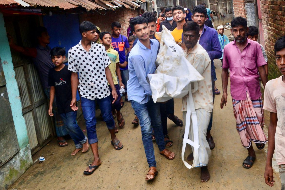 People carry the body of a landslide victim in Chittagong