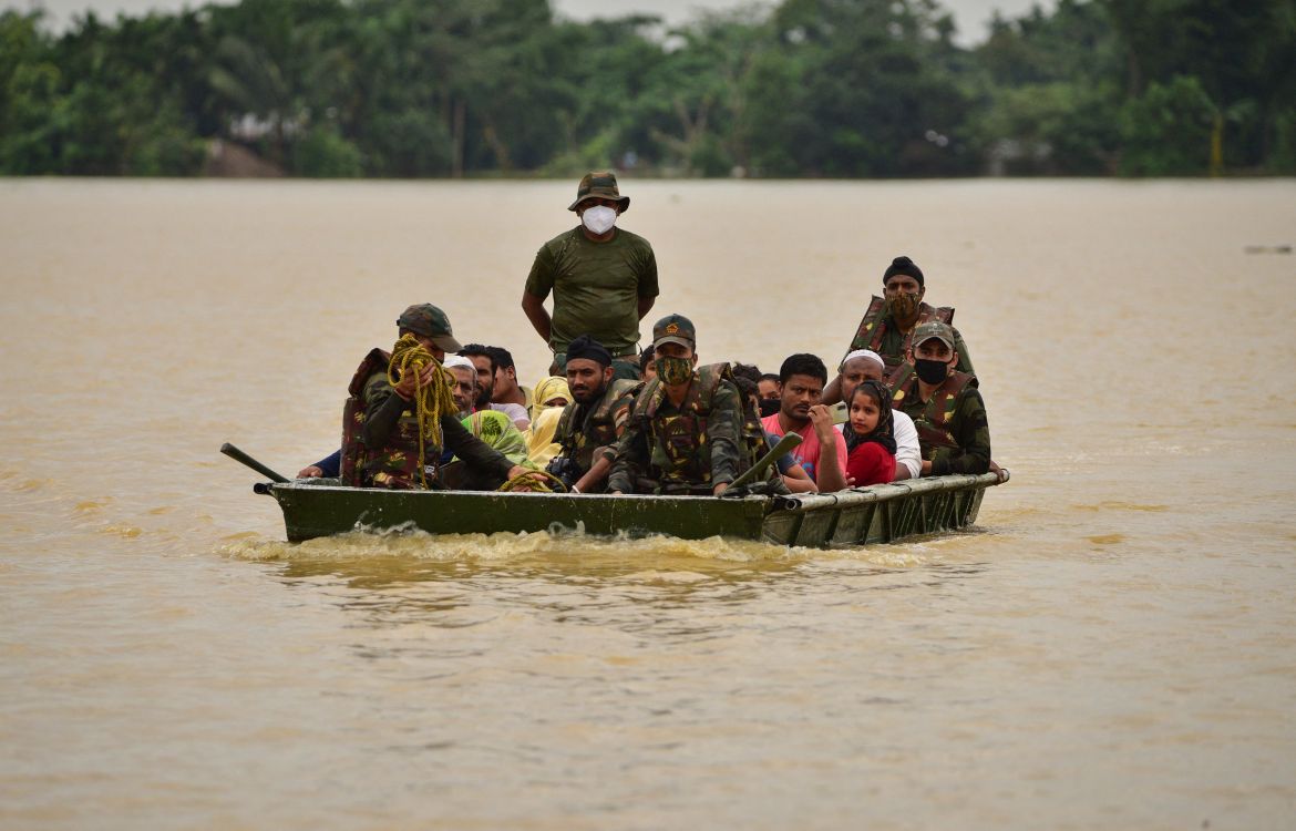 Indian Army soldiers evacuate people from flooded area to a safer place after heavy rains at a village in Hojai district, in the northeastern state of Assam, India