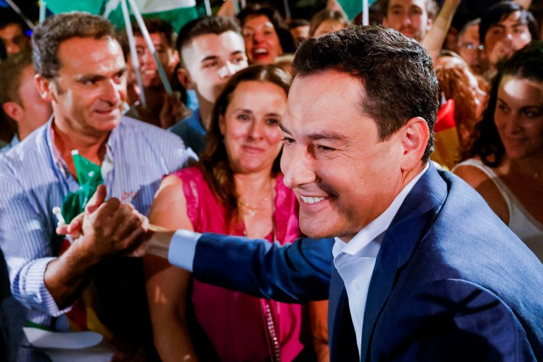 Andalusian Regional President and People's Party (PP) candidate Juan Manuel Moreno Bonilla greets supporters as he celebrates the result in Andalusian regional elections at the People's Party (PP) headquarters in Seville, Spain June 19, 2022. REUTERS/Marcelo del Pozo