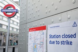 An informational poster placed outside Victoria Underground Station during a strike, in London, reads 'Station closed due to strike'
