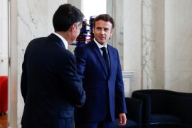French President Emmanuel Macron shakes hands with First Secretary of the Socialist Party (PS) Olivier Faure