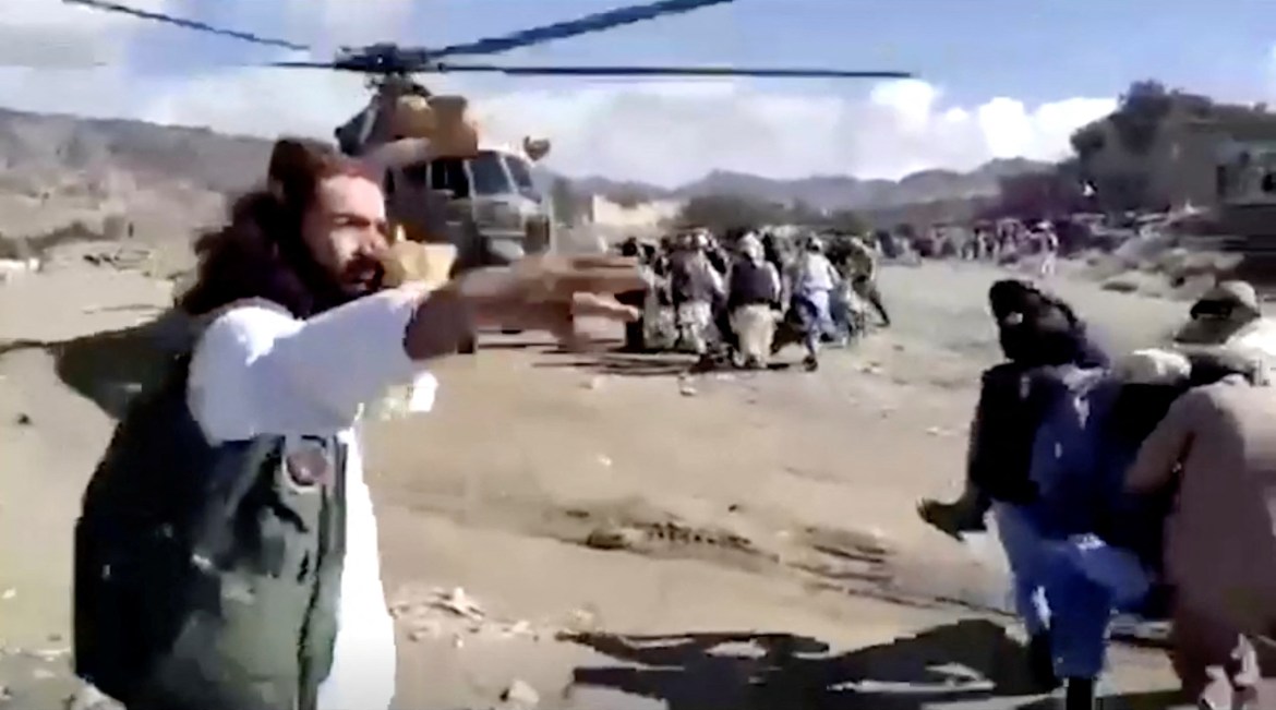 People carry injured to a helicopter