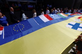 European lawmakers and Ukrainian representatives unfurl a 30-metre-long Ukrainian flag outside EU Parliament